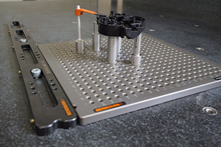 Quickload™ rail attached to a fixturing set-up that shows clamps and standoffs securing a workpiece