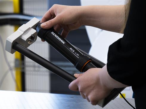 A person placing an RCS L-90 ballbar into an RCS calibrator
