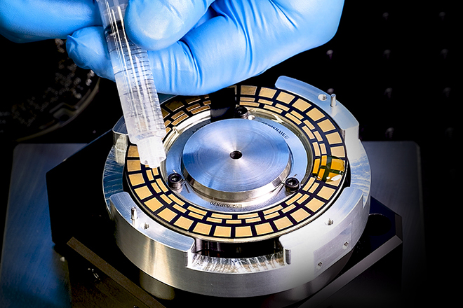 ASTRiA inductive encoder on a stand, being contaminated with liquid