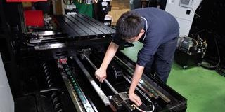 Engineer installing a FORTiS linear encoder on a machine tool