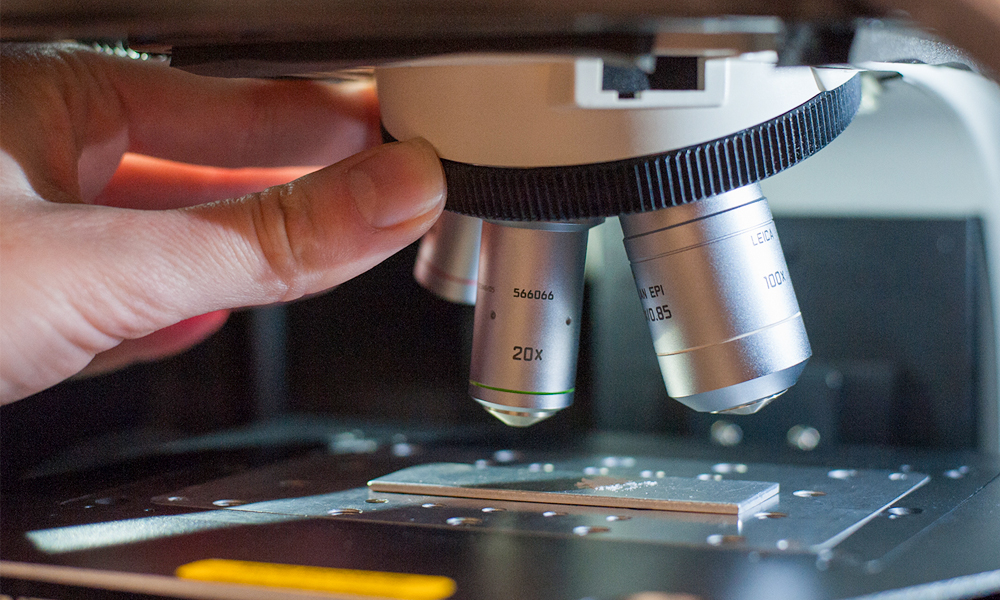 Hand adjusting a Raman microscope