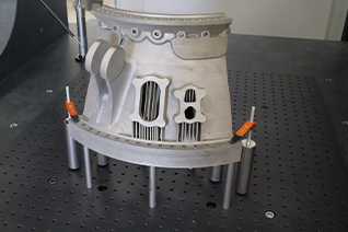 CMM fixture set-up on an AGILITY® fixture plate showing clamps and standoffs securing a workpiece