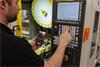 Machine operator inputting G-code from CARTO Ballbar Connect app into machine