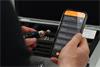 A hand holding mobile device displaying set-up screen of CARTO Ballbar Connect app and other hand holding QC20 ballbar